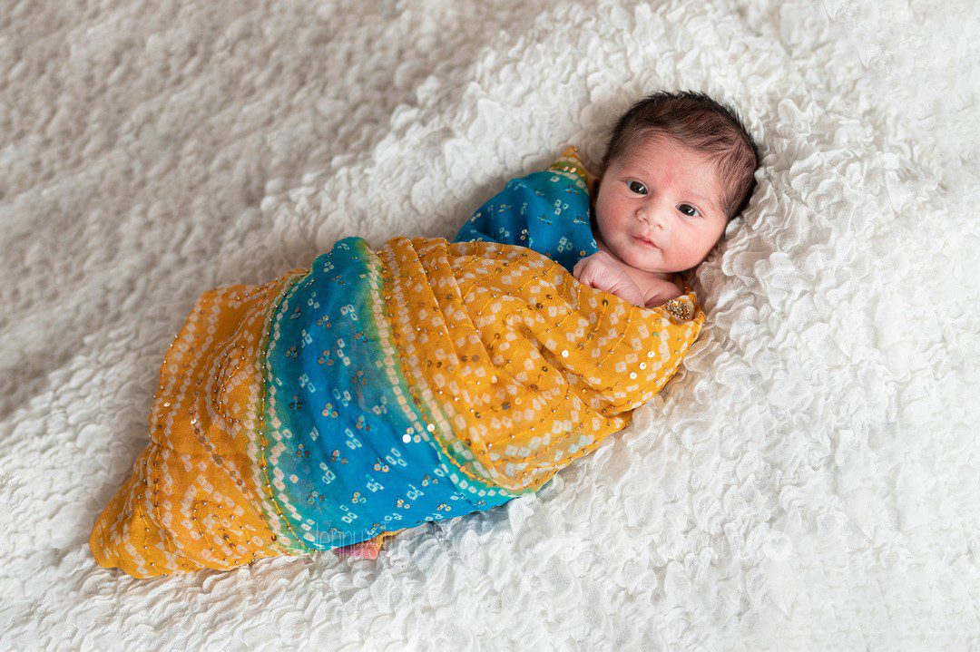 Baby wrapped in sequinned silks